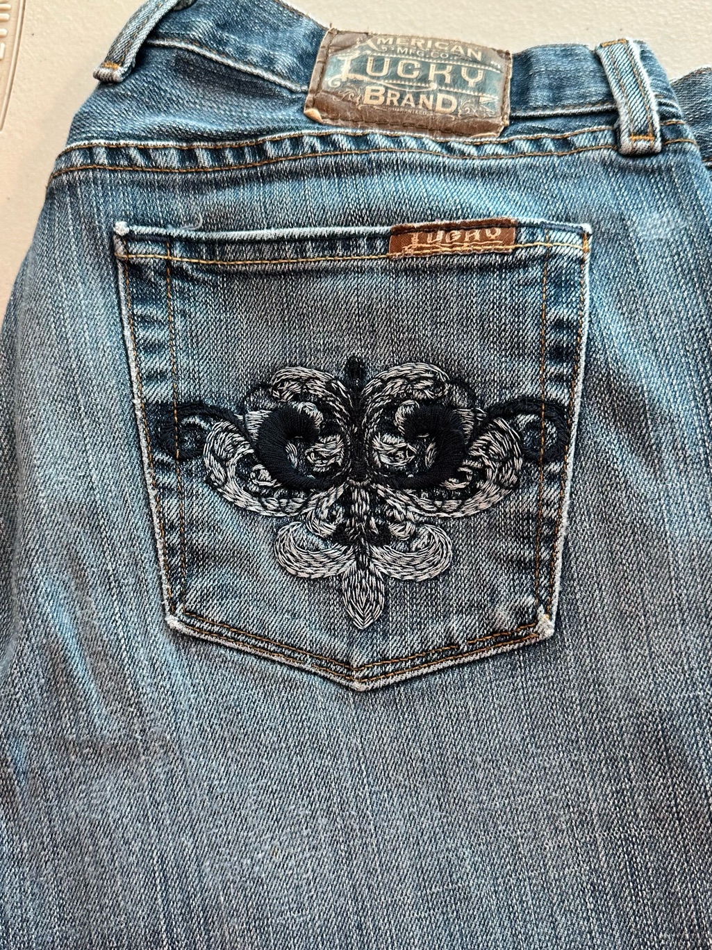 Lucky Brand Blue Denim Bootcut Jeans With Black Embroidered Pocket